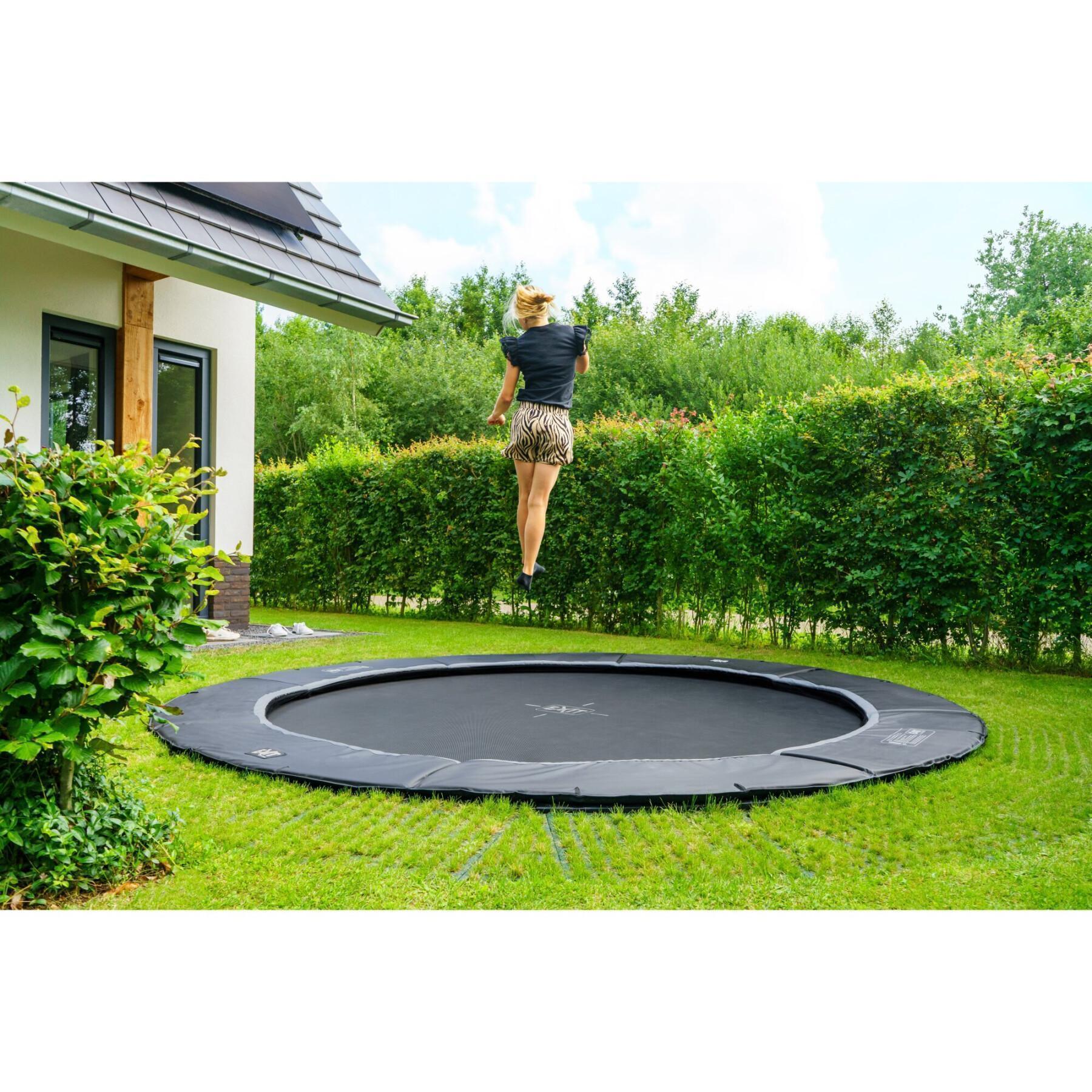 Trampoline buried at ground level with freezone safety tiles Exit Toys Dynamic 305 cm